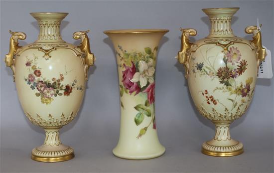A pair of Royal Worcester blush ivory twin-handled pedestal ovoid vases and a similar tapered cylindrical vase, H 23cm (pair)